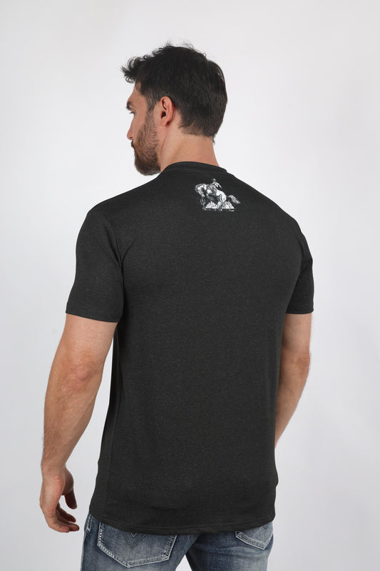 A man wearing a dark charcoal gray t-shirt with a small white graphic on the upper back, shown from a rear three-quarter view against a light gray studio background.