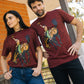 A man and a woman modeling matching heathered burgundy t-shirts with a graphic print of a cowboy riding a horse, posed outdoors on a porch.