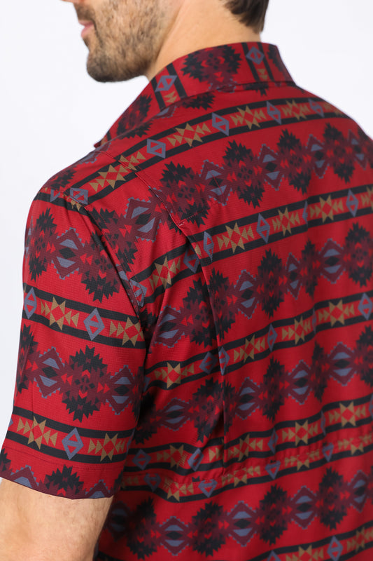 Man wearing a red western aztec performance shirt close up back