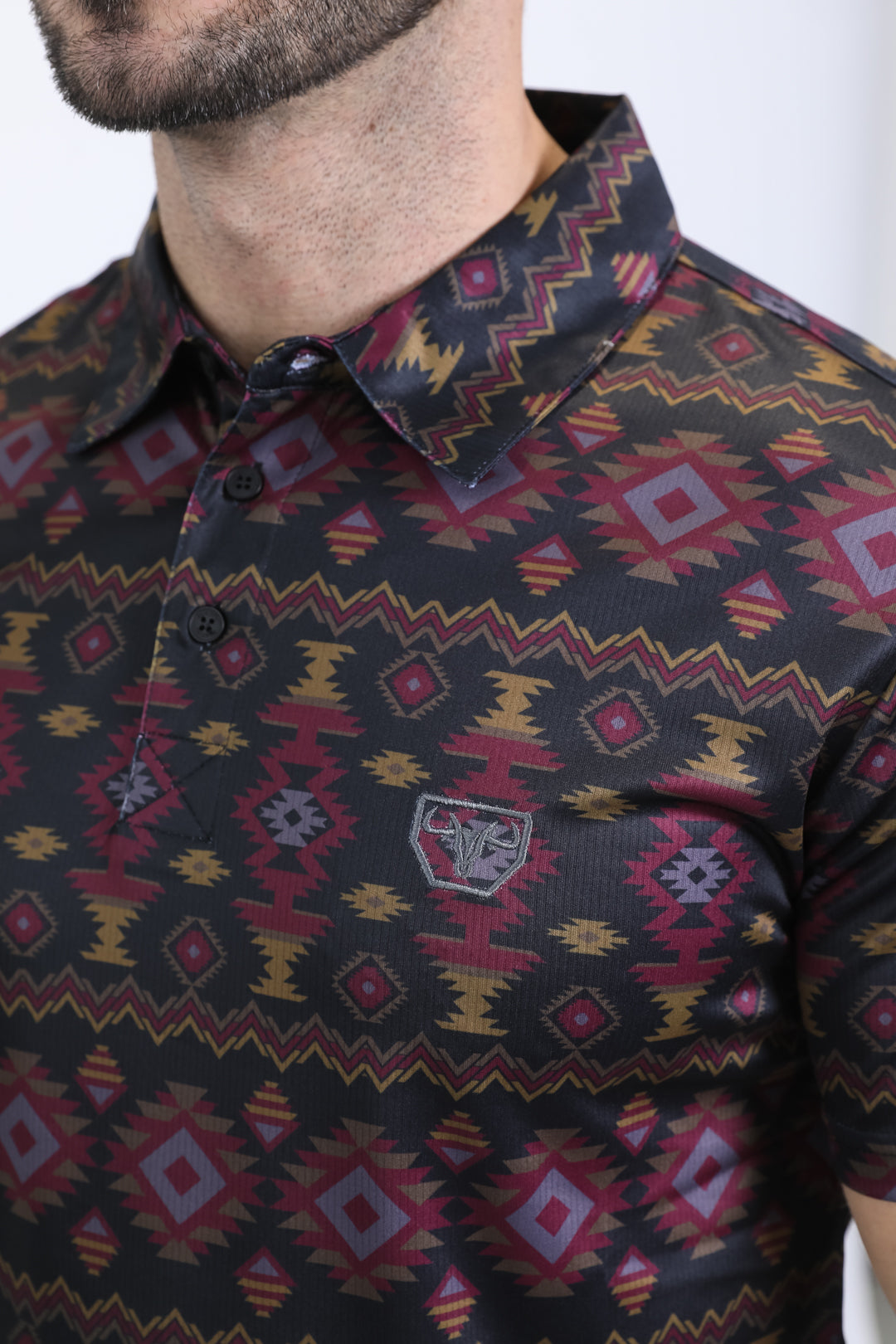 Close-up of a patterned shirt with a visible brand logo.