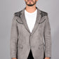 Man wearing a gray blazer with black embroidery on a gray background